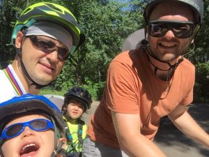Björn (right) is teaching his son Arn (center) the value of blending fitness and friends through weekly bike rides.