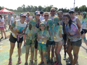 Along with teaching life lessons early, Heidi stays connected to her family by being active. Here she is with family and friends at the Color Run!
